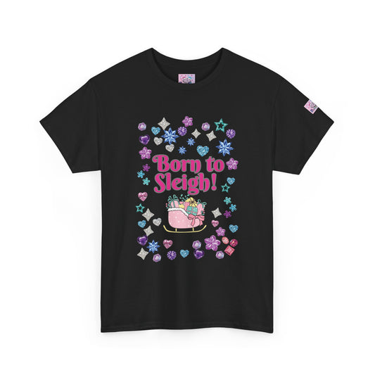A black short-sleeve t-shirt with a colorful Christmas-themed graphic on the front that reads 'Born to Sleigh!' in pink, surrounded by a sleigh with gifts and pastel snowflake, heart, and star shapes. A small brand tag is visible on the left sleeve.