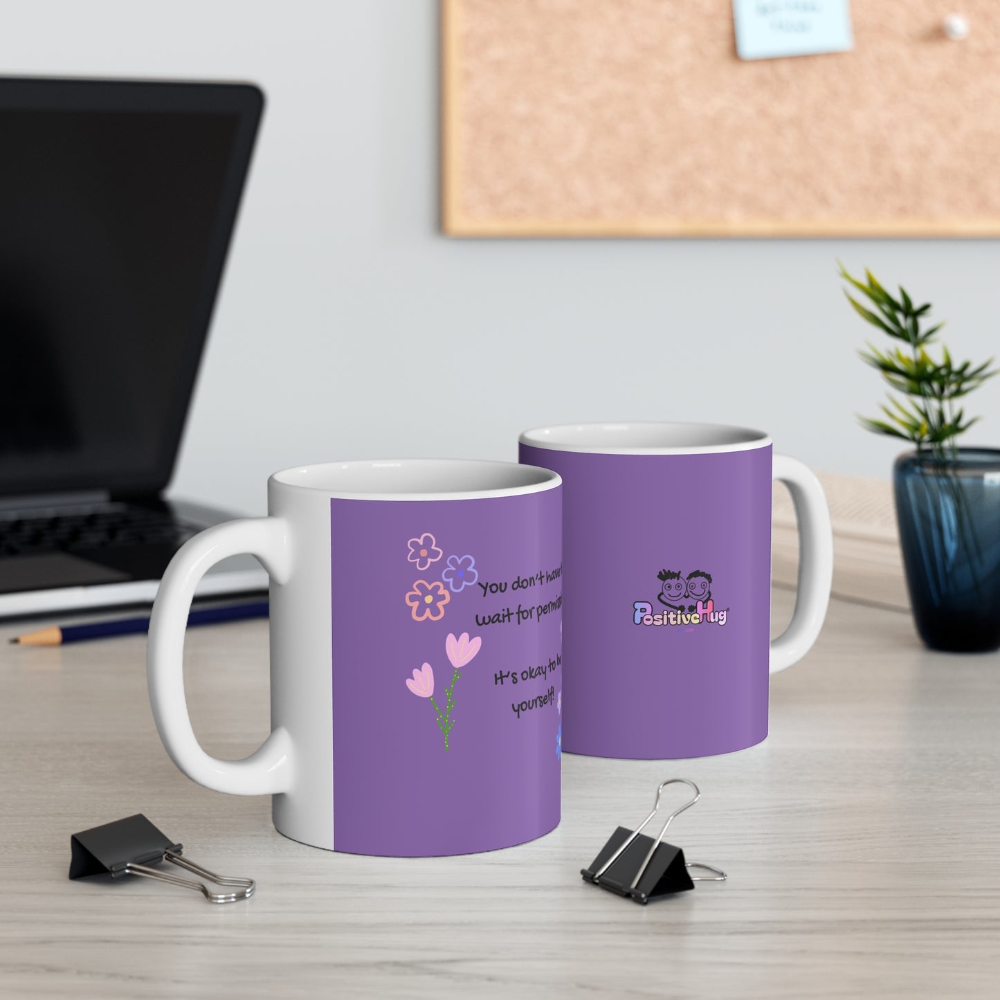 Two purple mugs with white handles on a desk with office supplies.