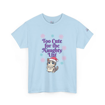 A light blue short-sleeve crewneck t-shirt featuring a festive graphic on the front. The graphic displays the purple text 'Too Cute for the Naughty List' above a cute cartoon cat wearing a Santa hat and holding a 'NAUGHTY LIST' sign, surrounded by pink and blue snowflakes.