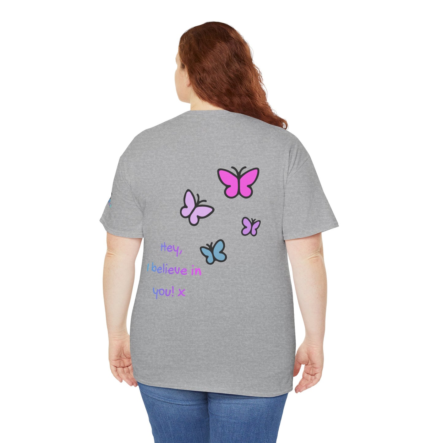 Person wearing a gray t-shirt with colorful butterfly designs and text on the back.