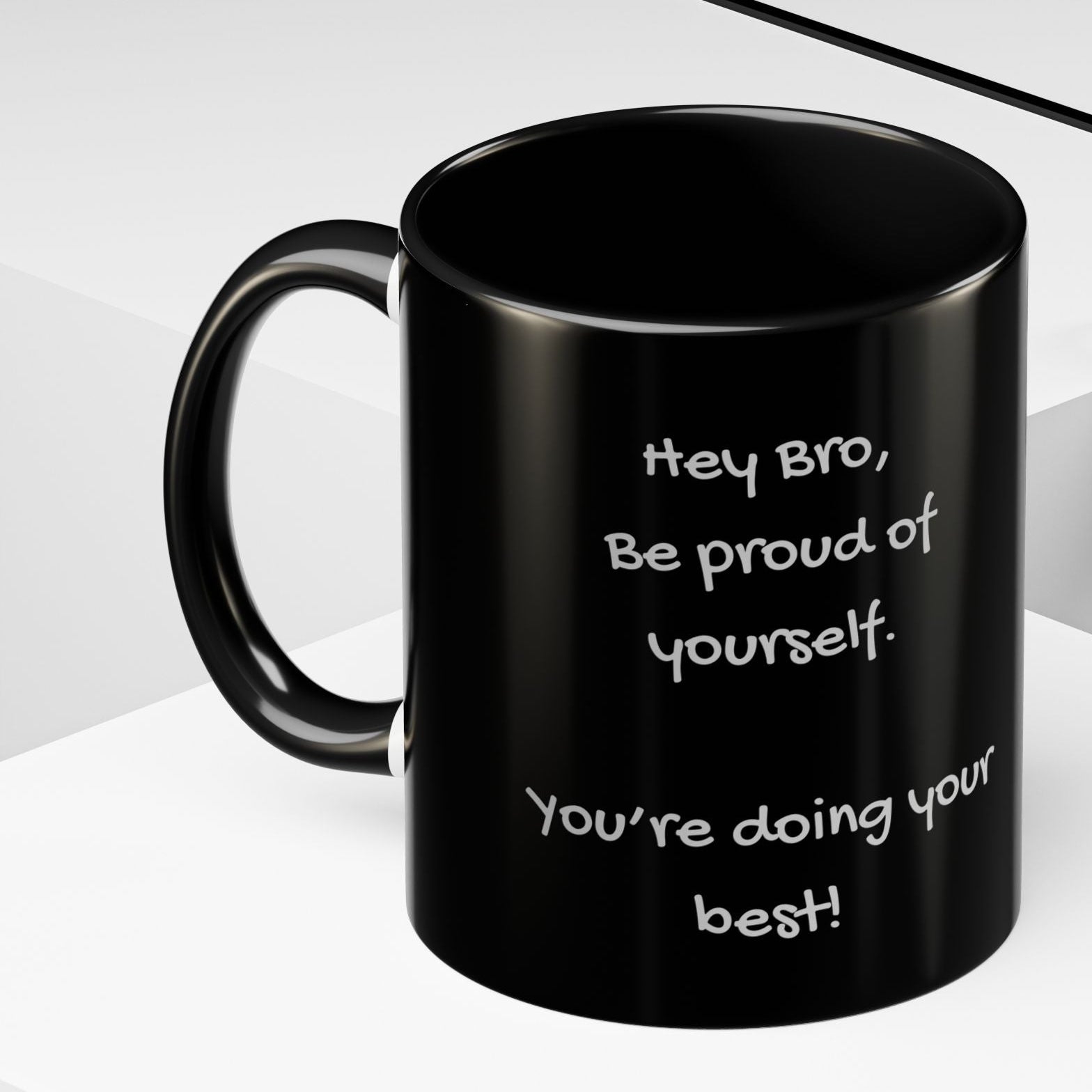 Black mug with grey writing design on a white surface