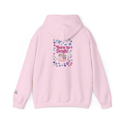 A light pink hoodie shown from the back, featuring a colorful graphic print with the text 'Born to Sleigh!' surrounded by hearts and a pink sleigh illustration.