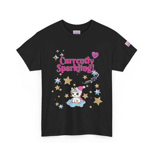 A black short-sleeve t-shirt with a colorful graphic on the front featuring the text 'Currently Sparkling!' in pink, a cute cartoon cat on a cloud, and stars. A small brand tag is visible on the left sleeve.