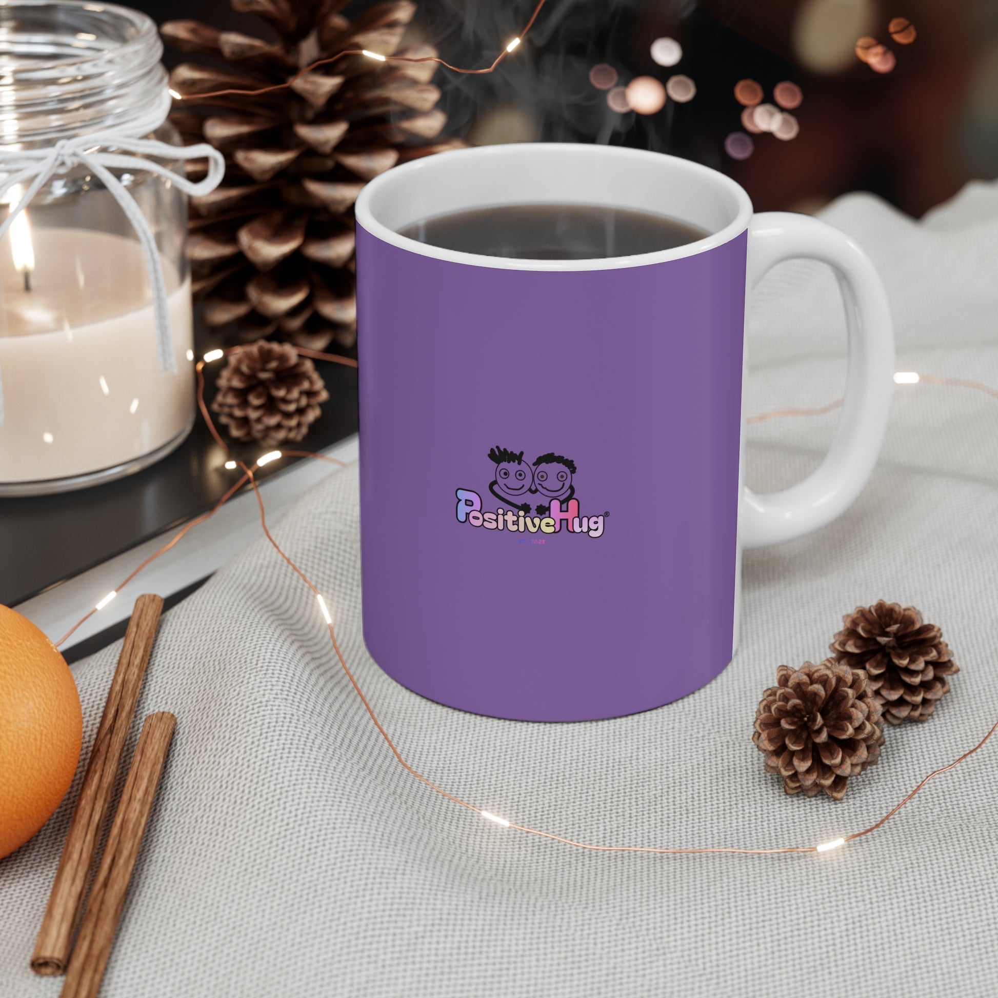 Purple mug with a logo on a table with decorative items