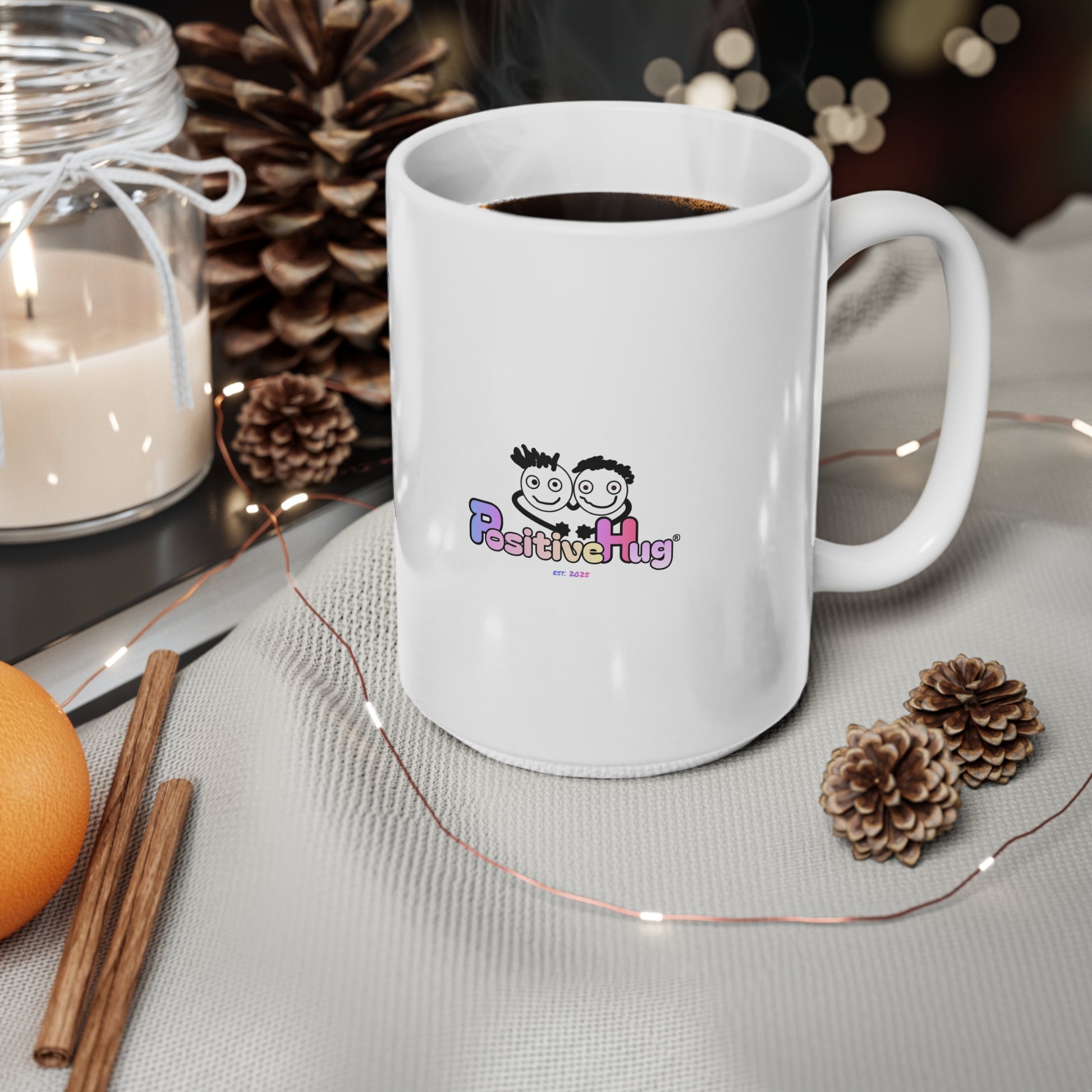 White mug with 'PositiveHug' logo on a table with decorative items