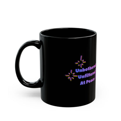 Black mug with colorful text and star designs on a white background