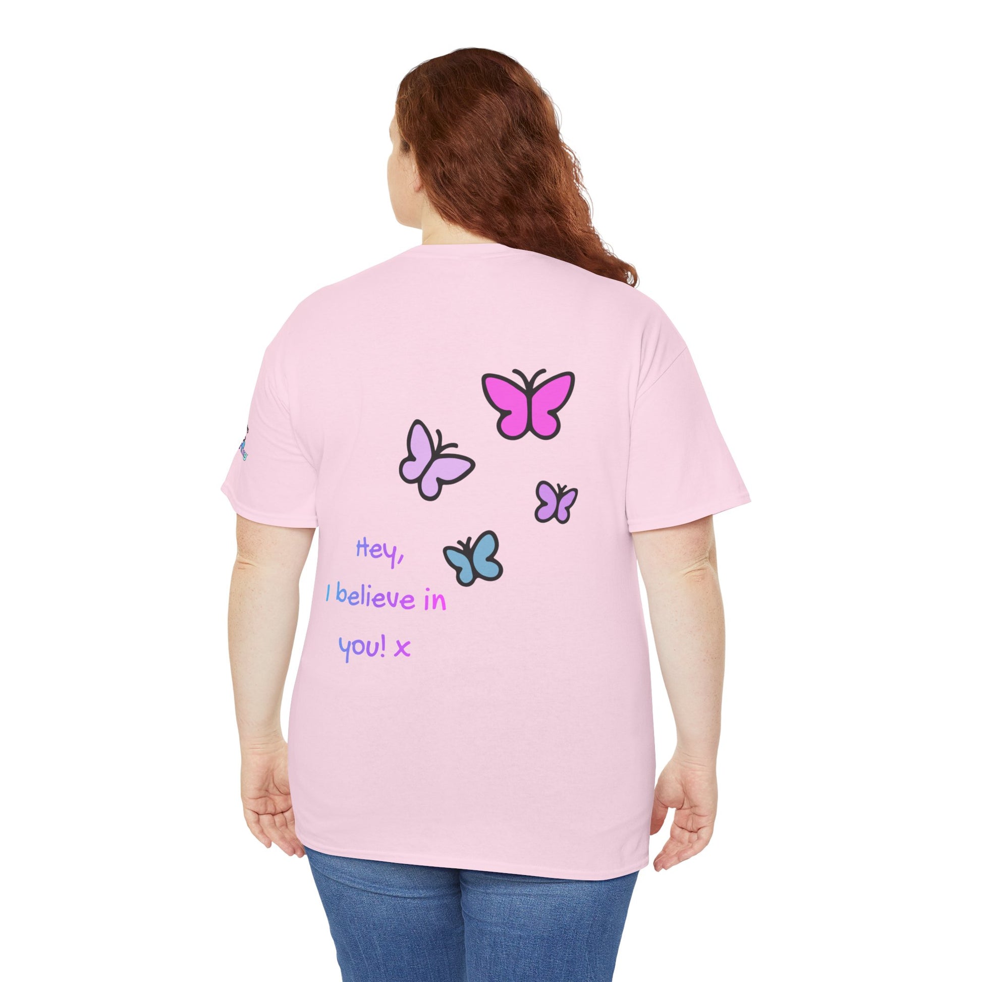Person wearing a pink t-shirt with butterfly designs and text on the back