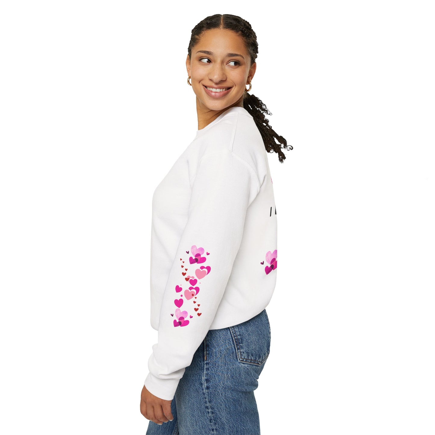 Woman wearing a white sweatshirt with pink heart designs on a white background