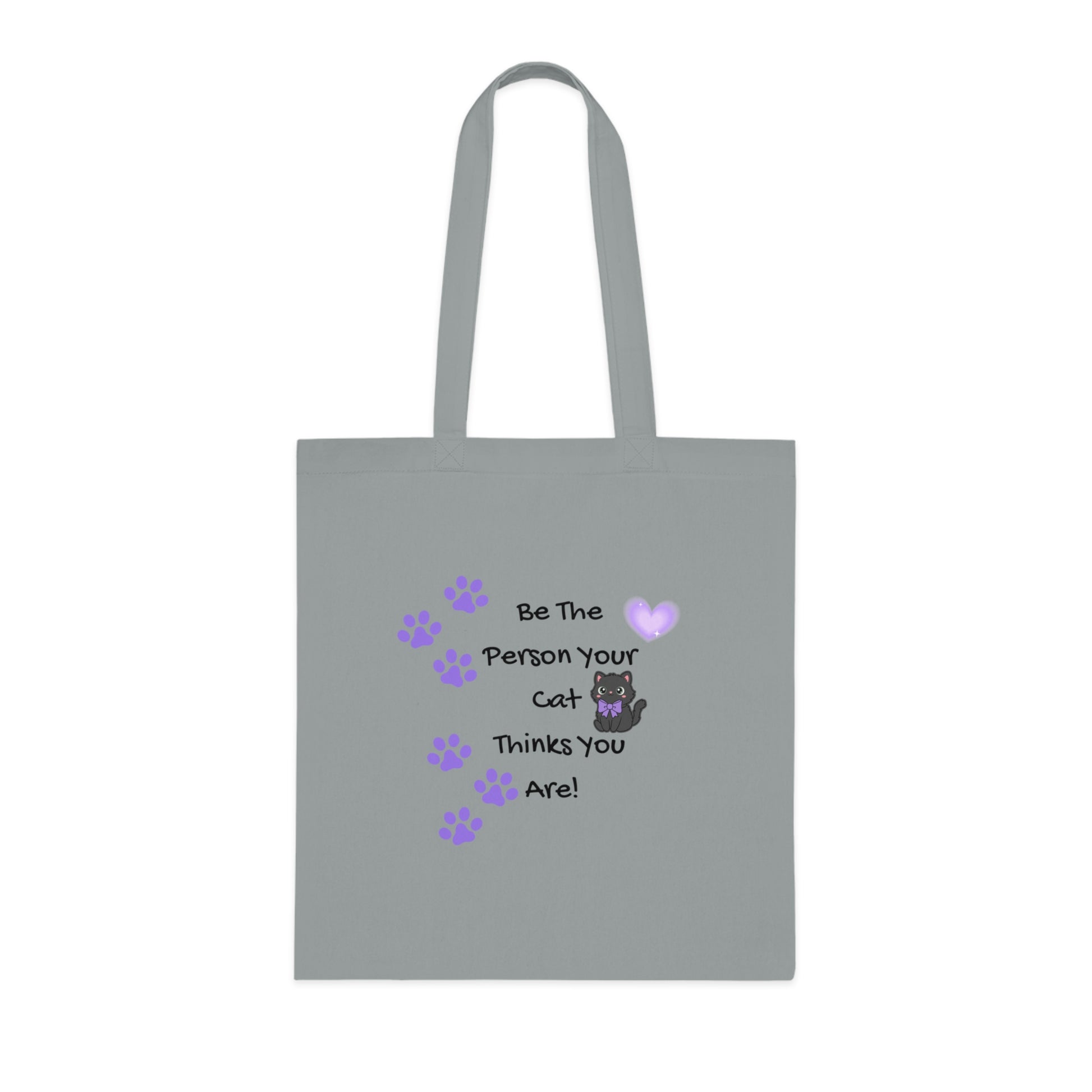 Gray tote bag with a cat-themed message and paw prints on a white background