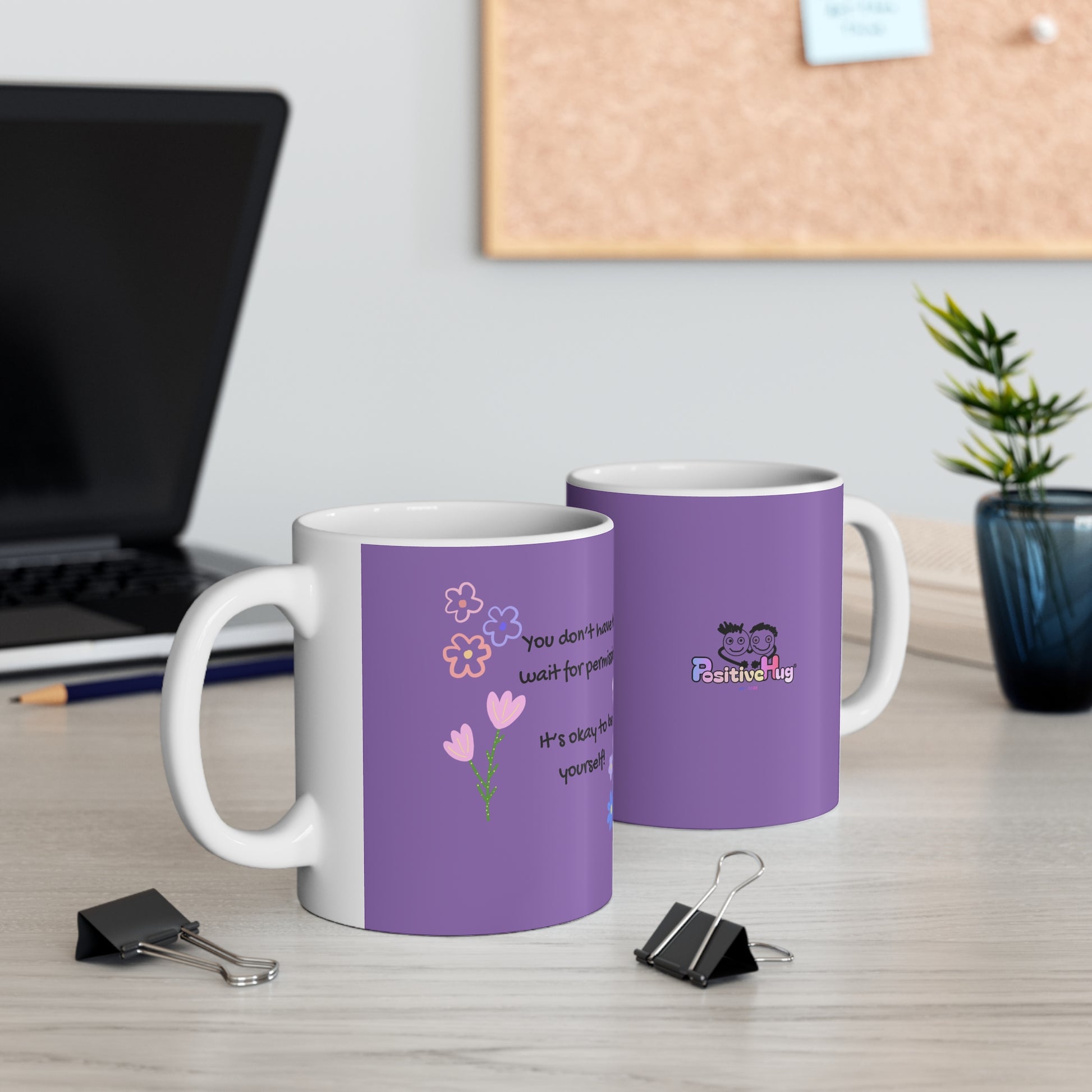 Two purple mugs with white handles on a desk with office supplies.