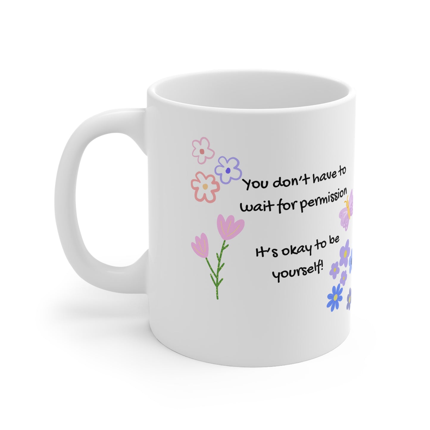White mug with floral designs and motivational quote on a white background