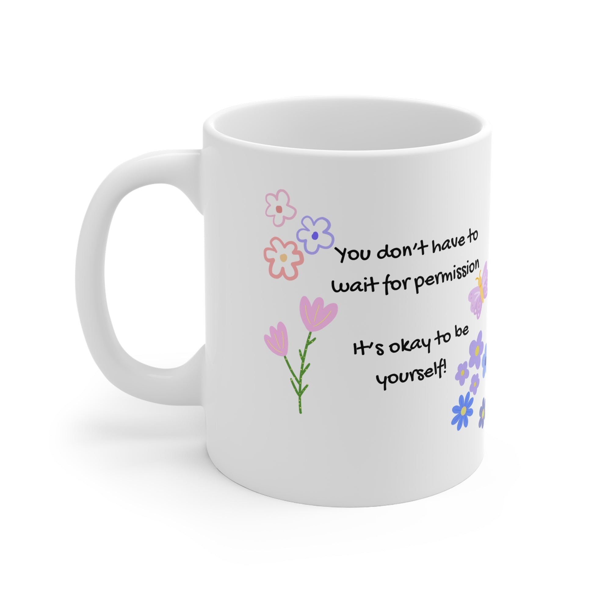 White mug with floral designs and motivational quote on a white background