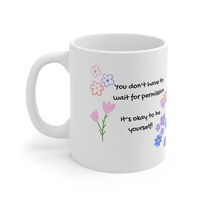 White mug with floral designs and motivational quote on a white background