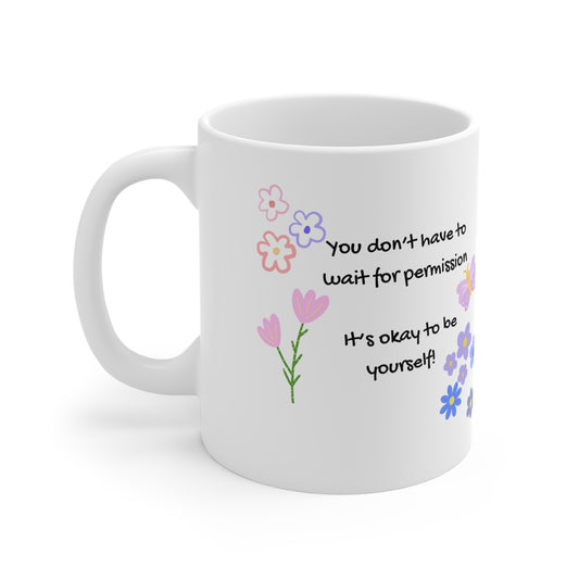 White mug with floral designs and motivational quote on a white background