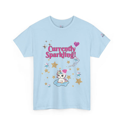 A light blue short-sleeve t-shirt with a cute cartoon graphic on the front. The graphic features the text 'Currently Sparkling!' in pink, a small white cat with a pink bow sitting on a cloud, and gold and pink stars.