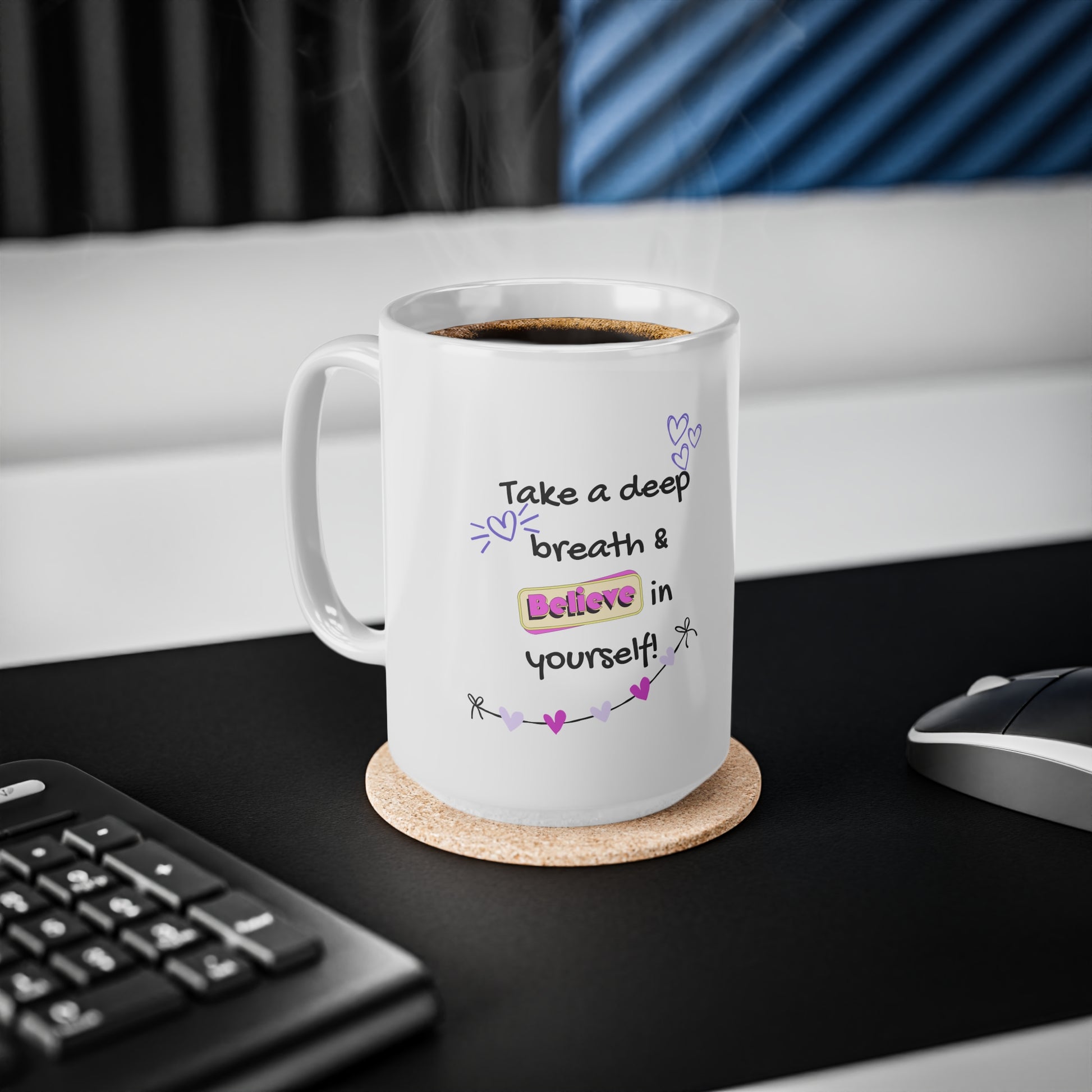 White mug with motivational quote on a desk with keyboard and mouse