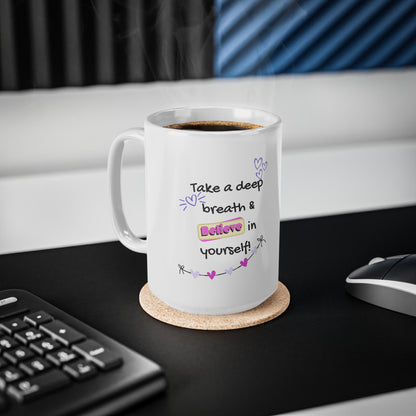 White mug with motivational quote on a desk with keyboard and mouse