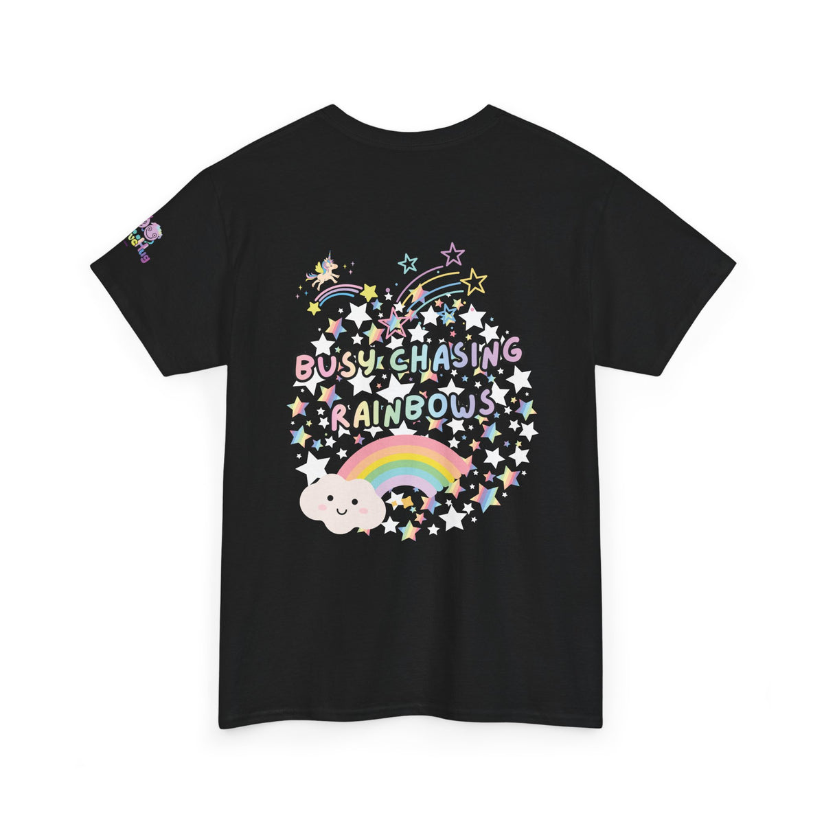 A black short-sleeve t-shirt with a colorful graphic on the front featuring the text 'BUSY CHASING RAINBOWS' surrounded by stars, a rainbow, and a cloud, shown on a plain white background.