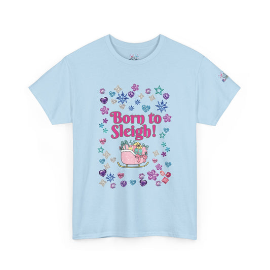 A light blue short-sleeve t-shirt with a festive Christmas graphic on the front. The graphic features the text 'Born to Sleigh!' in pink, surrounded by colorful snowflakes, stars, hearts, and a pink sleigh carrying gifts.