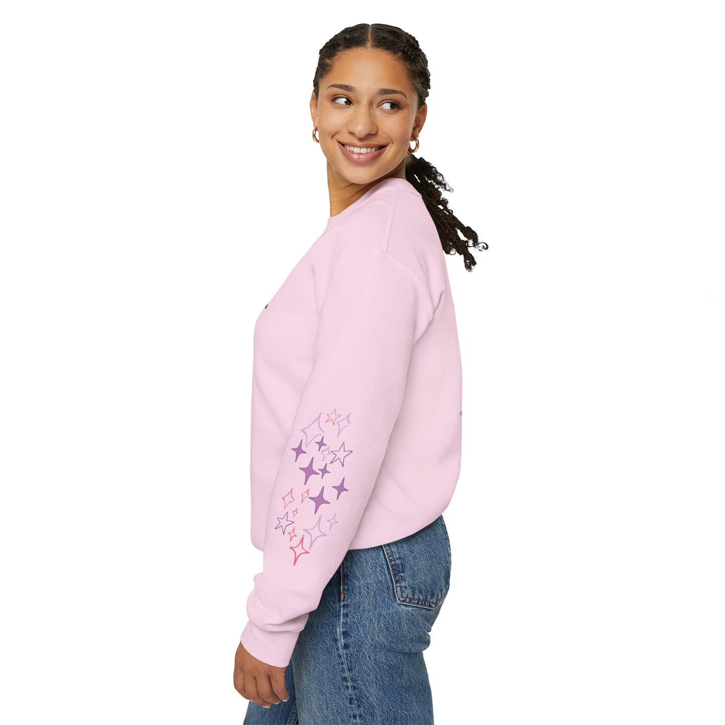 Woman wearing a pink sweatshirt with floral designs on a white background