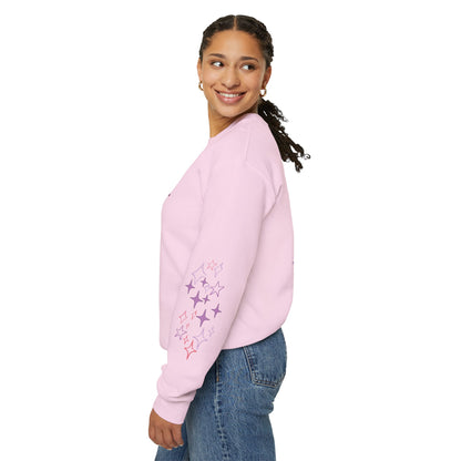 Woman wearing a pink sweatshirt with floral designs on a white background