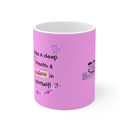 Pink mug with motivational quote and cartoon character on a white background