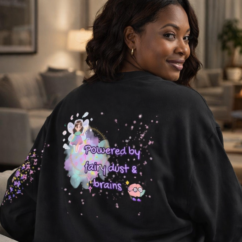 Person wearing a black sweatshirt with colorful design and text in a living room.